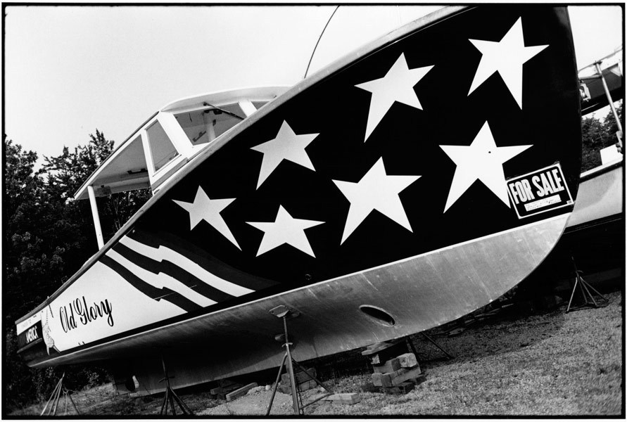 Boatyard Rt.1, Maine 
1996
 : OLD GLORY-Patriotism & Dissent 1966-2008 : LINN SAGE | Photography Editorial and Fine Art, New York, N.Y., Maine